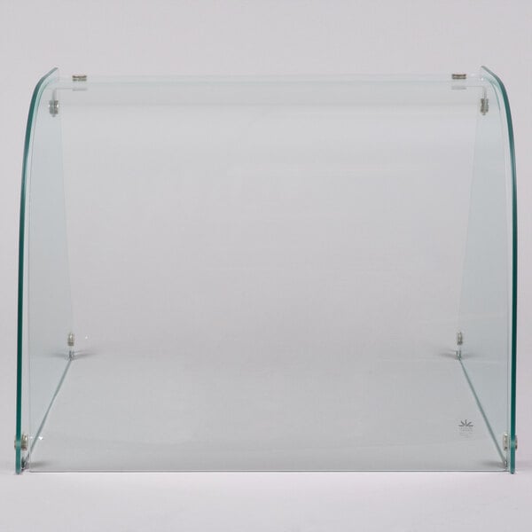 A clear curved glass sneeze guard.