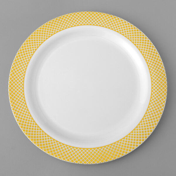 A white plate with yellow and white lattice design on the border.