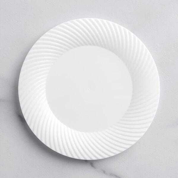 A white Visions plastic plate with a wavy design.