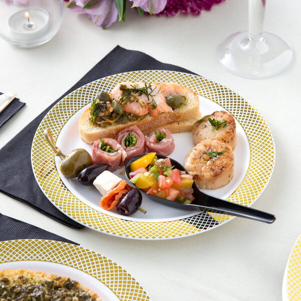 A Visions white plastic plate with food on a table.