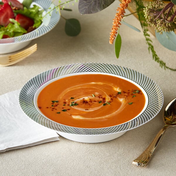 A Visions white bowl filled with soup and a spoon.