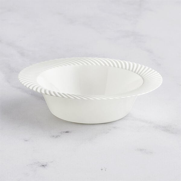 A Visions plastic bowl with a wavy edge.