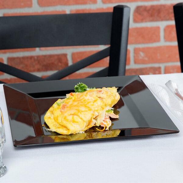 Egg omelet on a black square plastic plate in front of a black chair and red brick wall