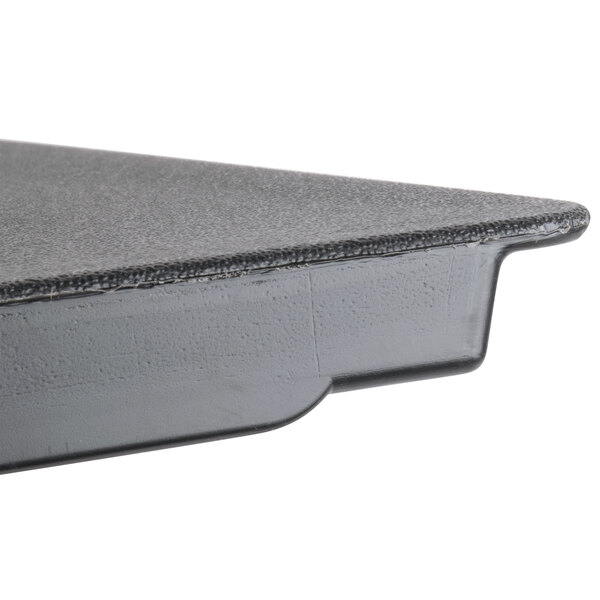 A black plastic door assembly with a gray top on a table.