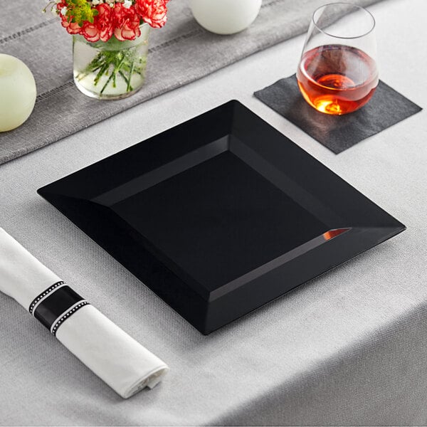 A black square Visions Florence plastic plate on a table.