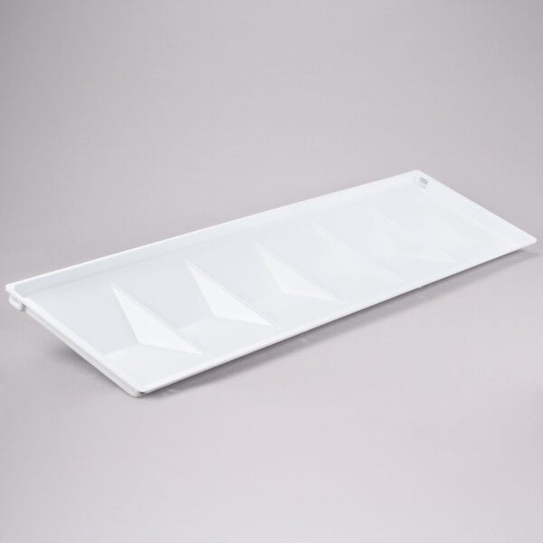 A white rectangular tray with triangular designs inside.