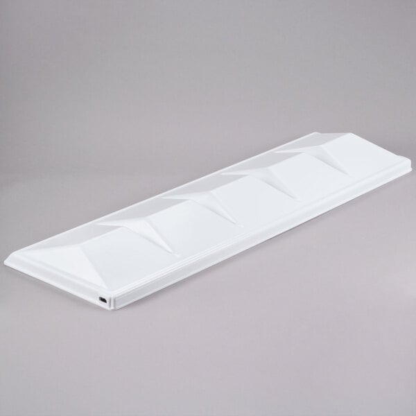 A white rectangular plastic baffle with a triangle pattern.