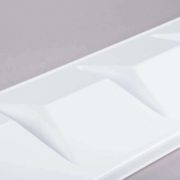 A white rectangular baffle with a triangle pattern.