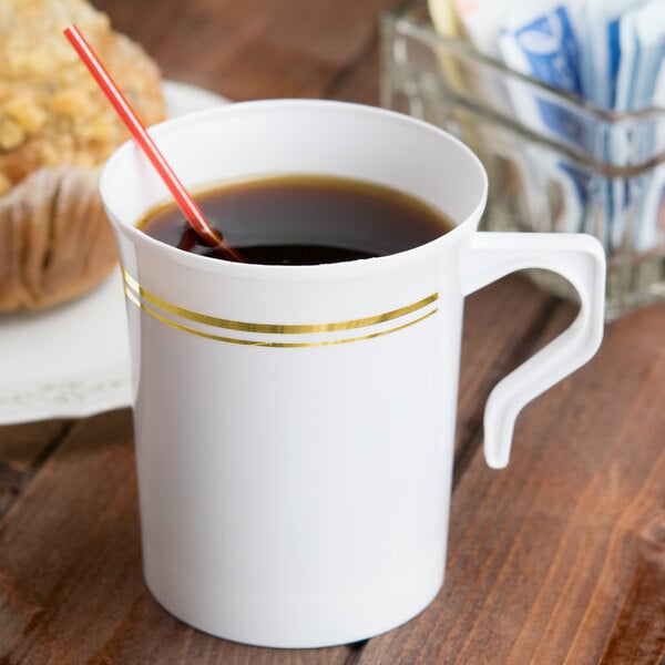 A white Visions plastic coffee mug with a straw in it.