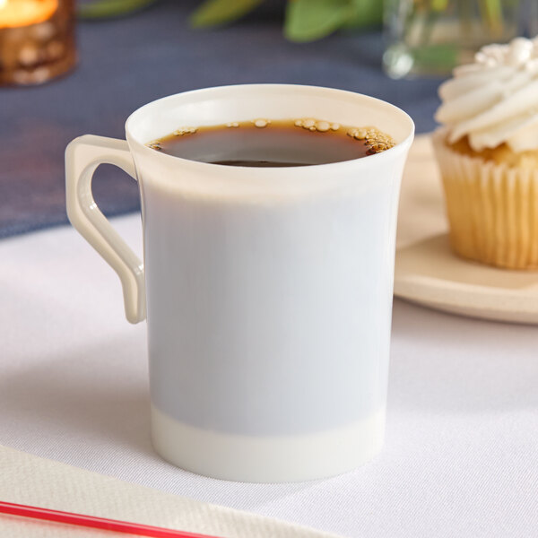 A bone or ivory-colored plastic coffee mug filled with coffee.