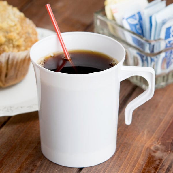 A white Visions plastic coffee mug with a straw in it.