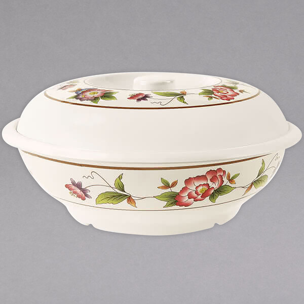 A white melamine bowl with a floral design on the lid.