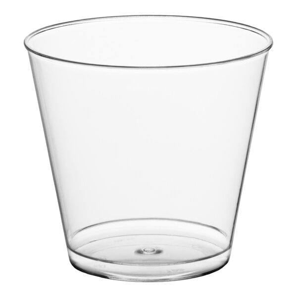 A clear plastic shot glass with a 1 oz. capacity.
