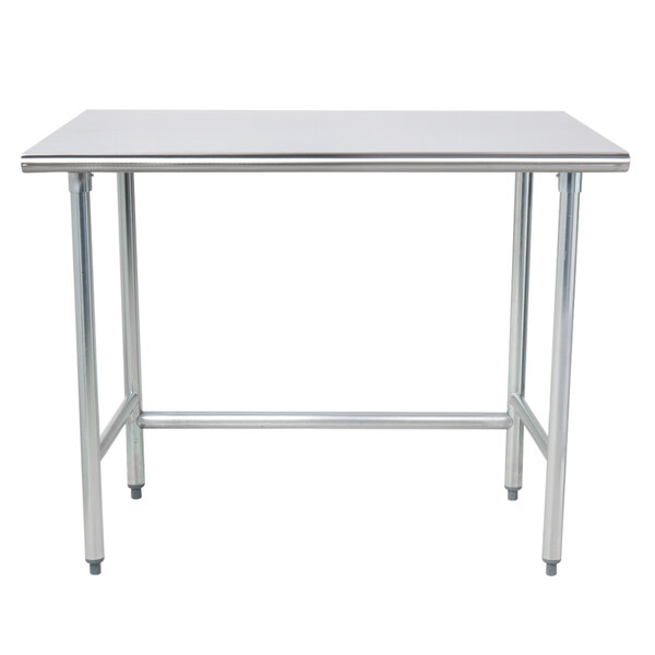 An Advance Tabco stainless steel work table with an open base and metal legs.