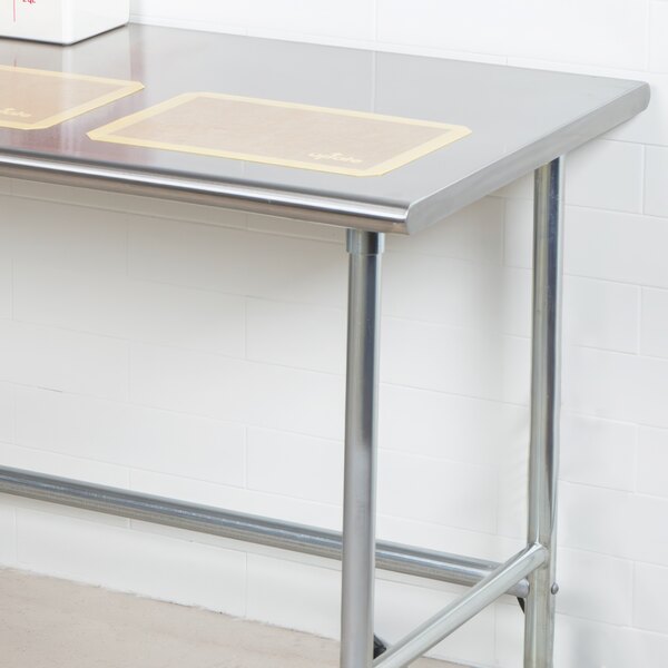 An Advance Tabco stainless steel work table with an open base.