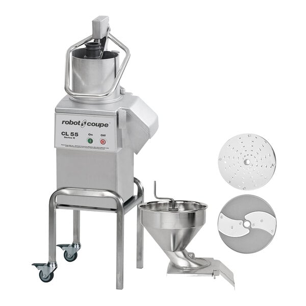 A Robot Coupe CL55 food processor with 2 feed heads and discs over a bowl.