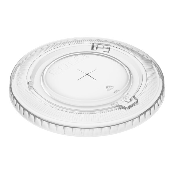 A clear plastic Solo lid with a straw slot designed for 12 and 14 oz. containers.