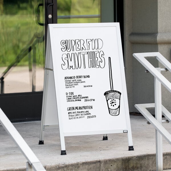 An Aarco white aluminum A-Frame sign with a drawing of a coffee cup on it.