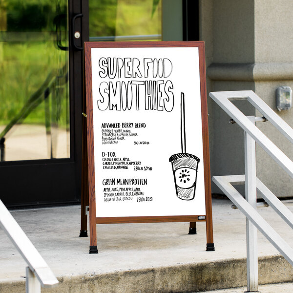 A cherry A-Frame sign with a white marker board on the sidewalk with a drawing of a pot.