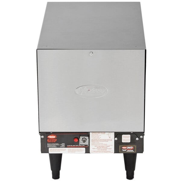 A Hatco booster water heater with a rectangular metal box and legs.