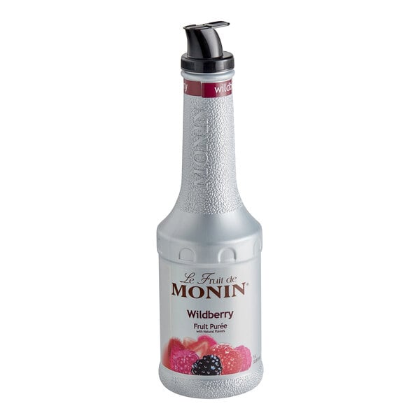 A close up of a silver Monin Wildberry Fruit Puree bottle with a black lid.