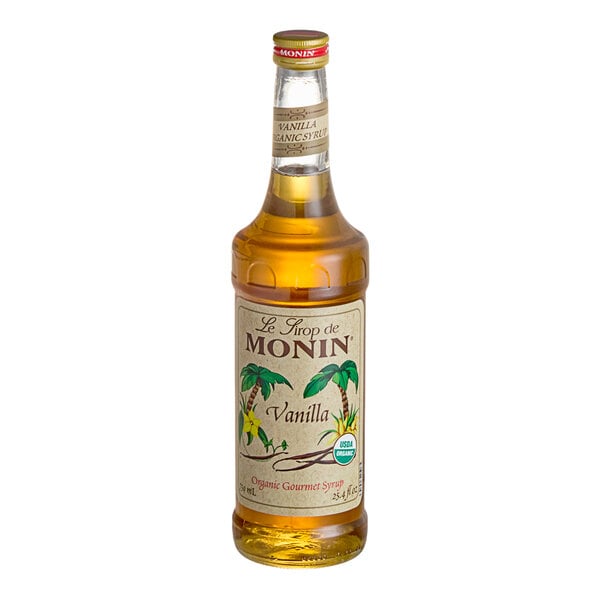 A Monin Organic Vanilla Flavoring Syrup bottle with a label.