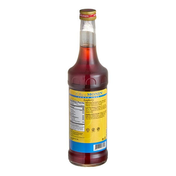A bottle of Monin Sugar-Free Raspberry Fruit Syrup with a yellow label.