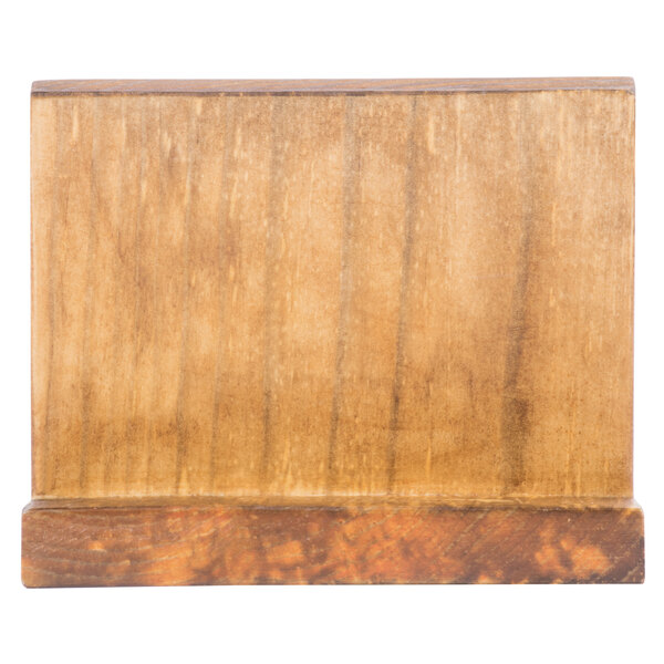 A brown wood block with a black chalkboard surface.