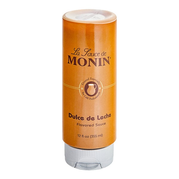 A bottle of Monin Dulce de Leche flavoring sauce on a white background.