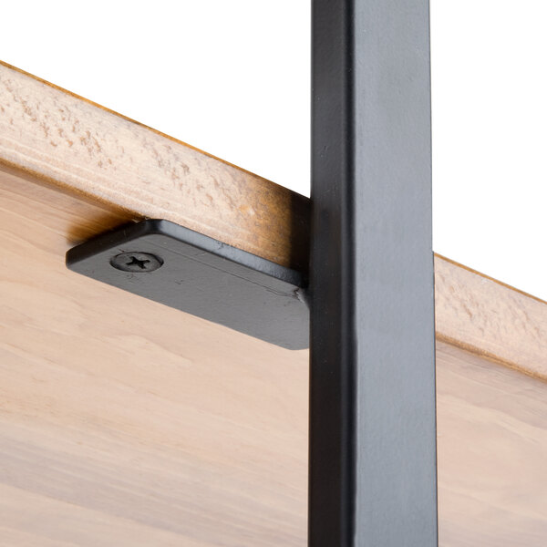 A black metal frame with metal brackets on wooden shelves.