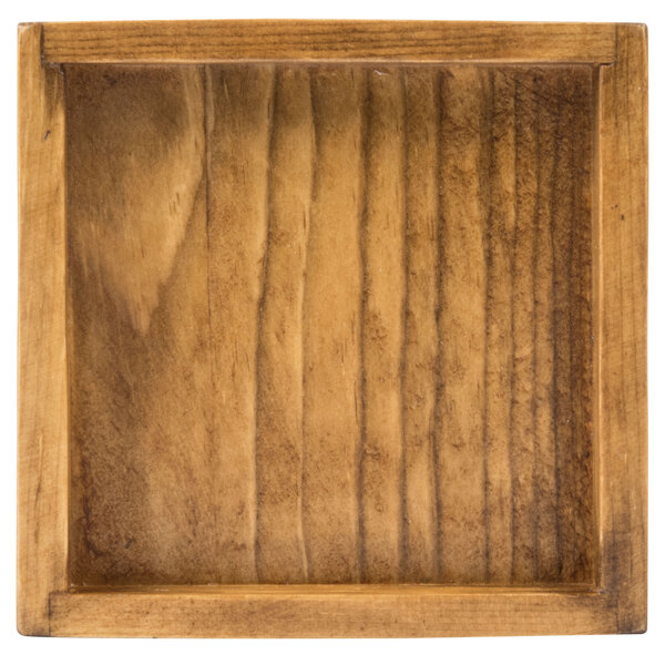 A square wooden riser with a jar in it.