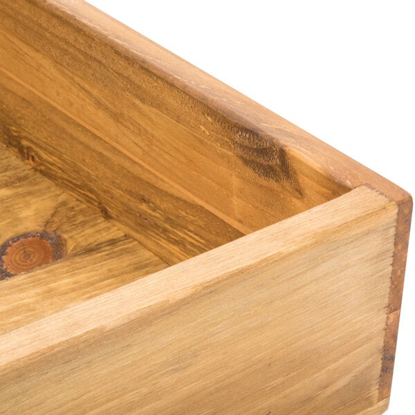 A wooden square display riser with a hole in the middle.