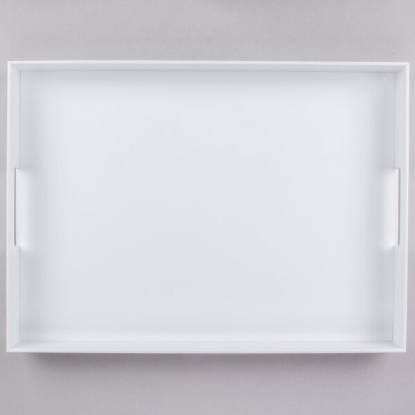 A white rectangular Cal-Mil plastic room service tray with handles.
