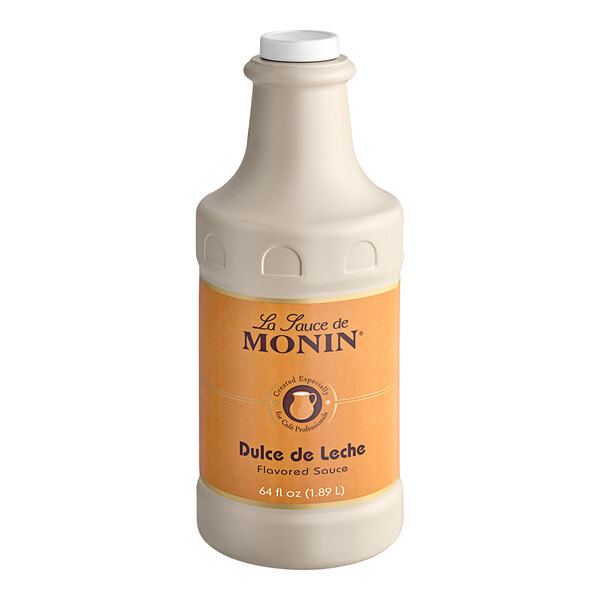 A white Monin bottle of liquid flavoring sauce with a white label and lid.