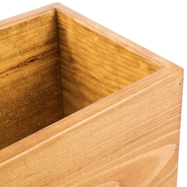 A wooden rectangular plate riser with a hole in the middle.