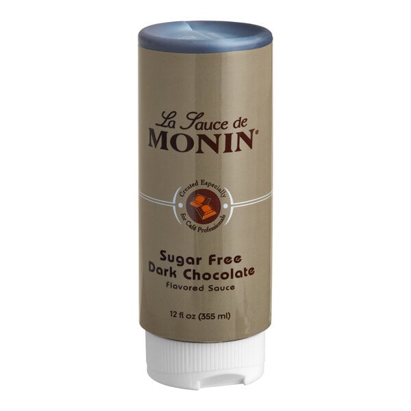 A brown Monin container with a blue label and lid for Sugar Free Dark Chocolate Flavoring Sauce.