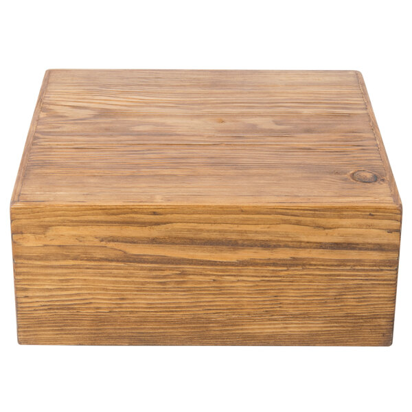 A Cal-Mil rustic pine cooling base with a lid on a wood surface.