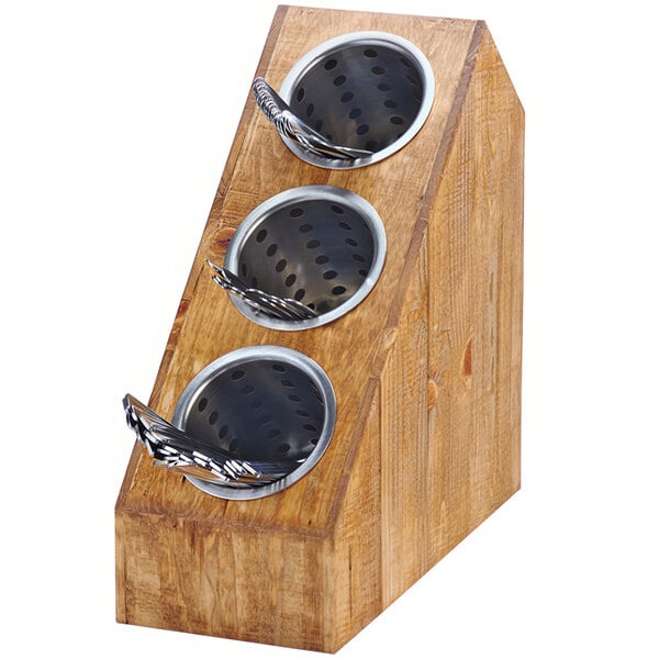 A wooden box with three slanted metal bowls on top.