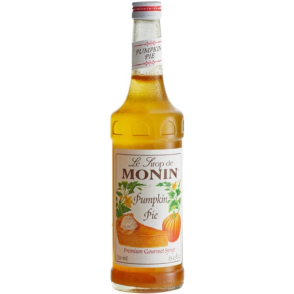 A bottle of Monin pumpkin pie flavoring syrup with a label.