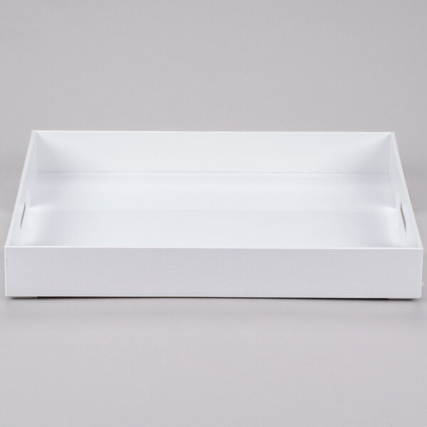 A white rectangular Cal-Mil plastic room service tray with handles.