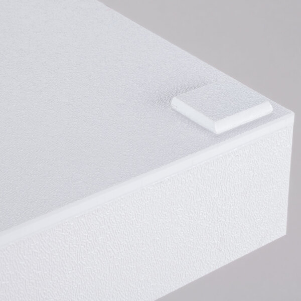 A white rectangular plastic tray with handles on a white surface.