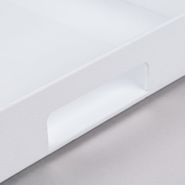 A white plastic Cal-Mil room service tray with handles.