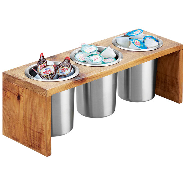 A wooden tray with three Cal-Mil containers and two cups on a counter.