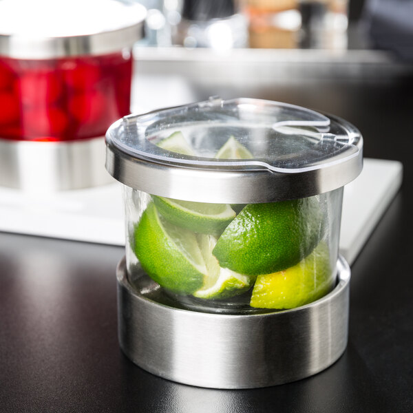 A Cal-Mil chilled condiment organizer with limes and a notched lid.