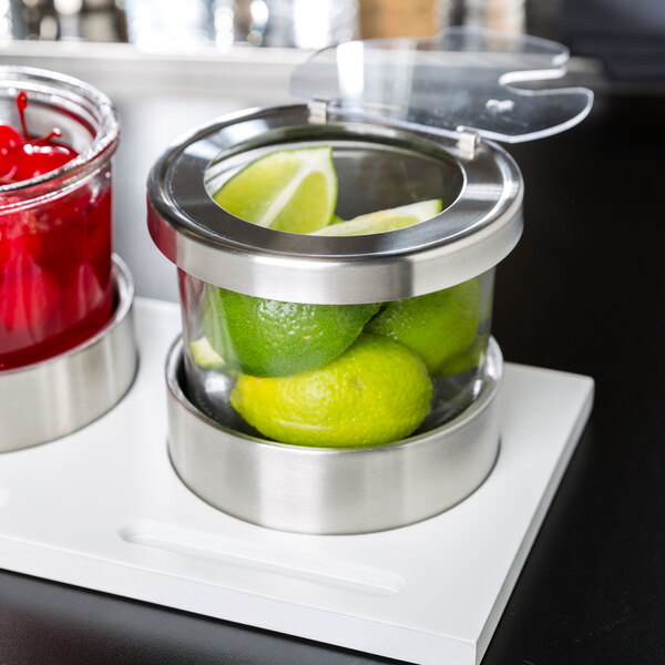 A Cal-Mil chilled organizer with limes and a jar of cherries.