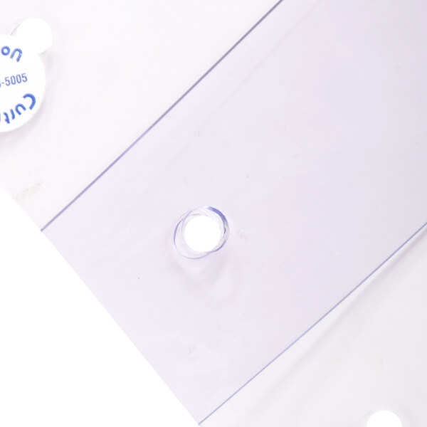 A close-up of a clear plastic Curtron door strip with holes in it.