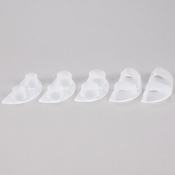 A group of white plastic Cal-Mil portion cups with round tops.