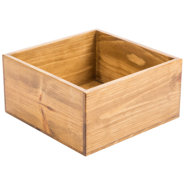 A wooden square riser with a square top on a table.