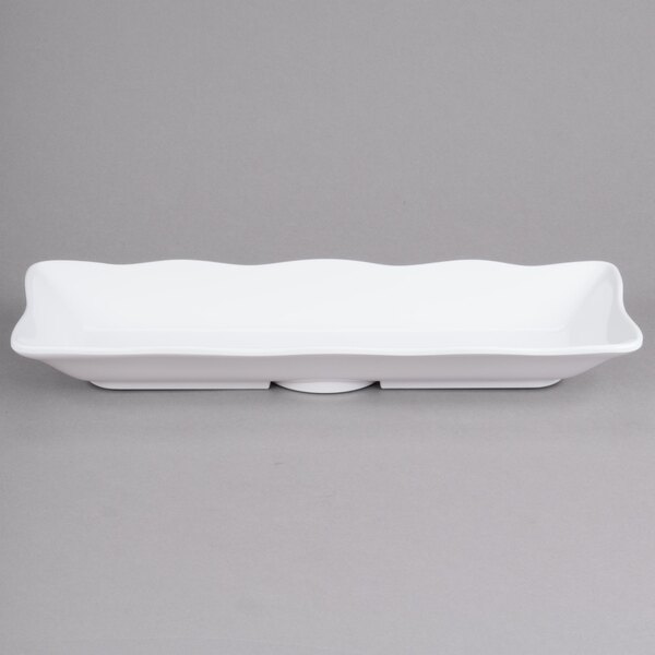 A white rectangular melamine tray with a scalloped edge.