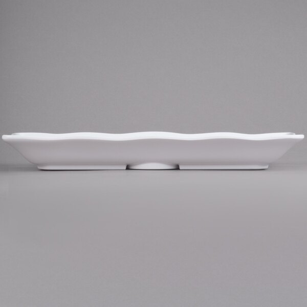 A white rectangular Elite Global Solutions melamine tray with scalloped edges.